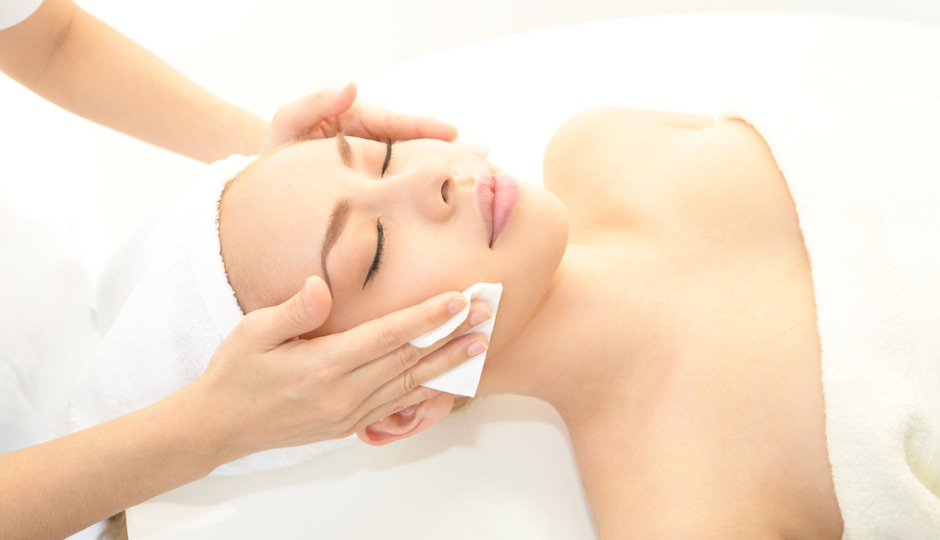 Image of woman receiving a facial treatment from esthetician