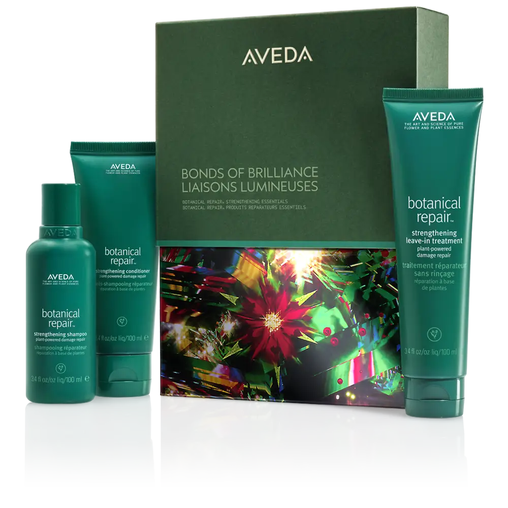 Aveda Bonds of Brilliance gift set features three green bottles of botanical repair hair products in a decorative box—perfect for radiant hair and Winter Hair Rituals.